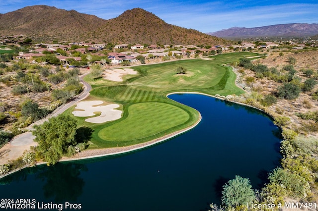 birds eye view of property with a water and mountain view