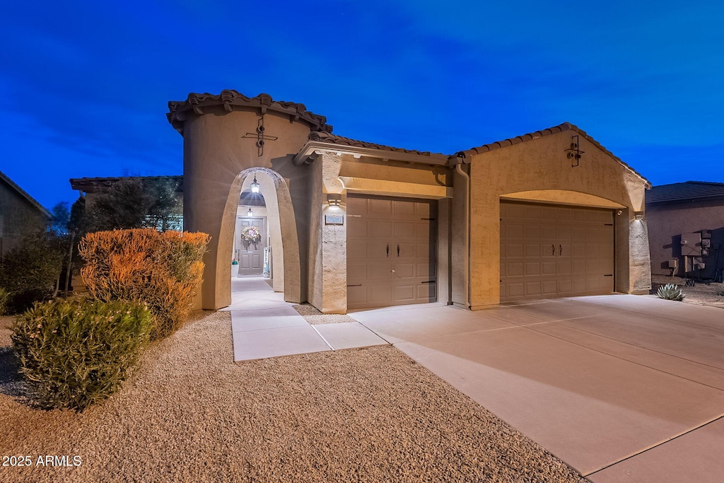 mediterranean / spanish-style house featuring a garage