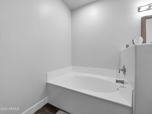 14000 N 94th St Unit 1008, Scottsdale, AZ 85260 - full bathroom featuring a bath, wood finished floors, and baseboards