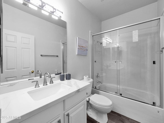 14000 N 94th St Unit 1008, Scottsdale, AZ 85260 - full bathroom with wood finished floors, vanity, toilet, and enclosed tub / shower combo