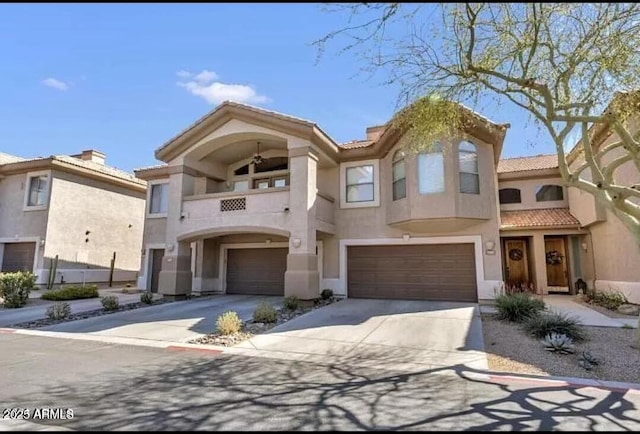 14000 N 94th St Unit 1008, Scottsdale, AZ 85260 - view of front of property with a tiled roof, concrete driveway, a garage, a balcony, and stucco siding
