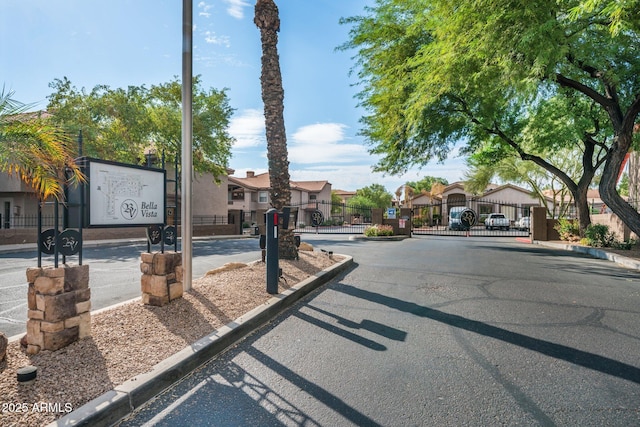 14000 N 94th St Unit 1008, Scottsdale, AZ 85260 - view of street featuring a gate, a gated entry, curbs, and a residential view