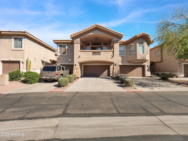 14000 N 94th St Unit 1008, Scottsdale, AZ 85260 - view of front facade with a tile roof, driveway, a garage, a balcony, and stucco siding