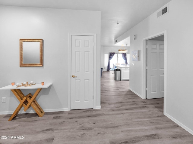 14000 N 94th St Unit 1008, Scottsdale, AZ 85260 - hall featuring wood finished floors, visible vents, and baseboards