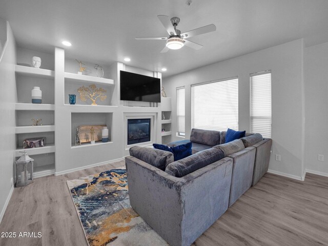 14000 N 94th St Unit 1008, Scottsdale, AZ 85260 - living area with baseboards, recessed lighting, built in shelves, a ceiling fan, and wood finished floors