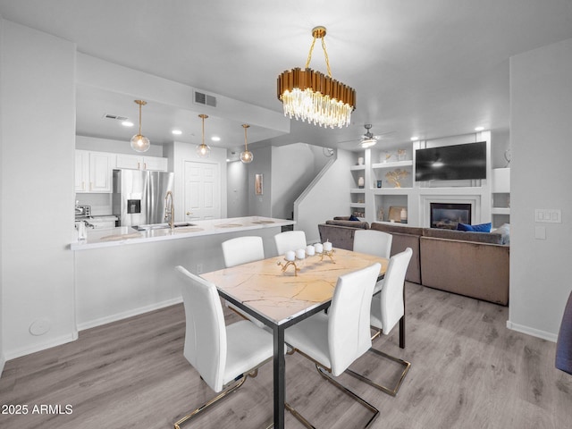 14000 N 94th St Unit 1008, Scottsdale, AZ 85260 - dining space featuring light wood-type flooring, visible vents, and ceiling fan