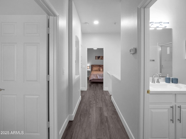 14000 N 94th St Unit 1008, Scottsdale, AZ 85260 - corridor featuring baseboards, a sink, and dark wood-style floors