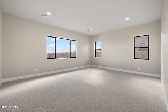 spare room with light colored carpet