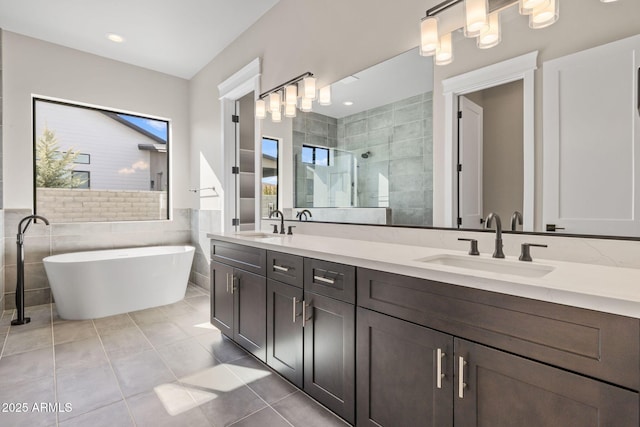 bathroom featuring tile walls, vanity, tile patterned floors, and shower with separate bathtub