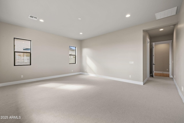 carpeted spare room with a healthy amount of sunlight