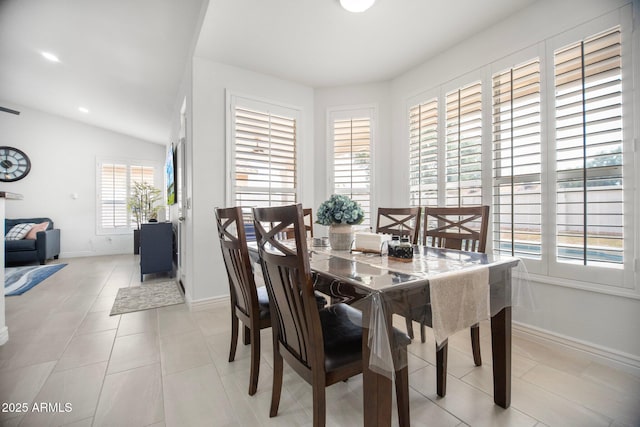 13629 N 71st Dr, Peoria, AZ 85381 - dining space with light tile patterned flooring, vaulted ceiling, and baseboards