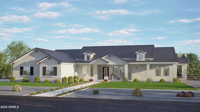 view of front of property with stucco siding, a front yard, and a tile roof