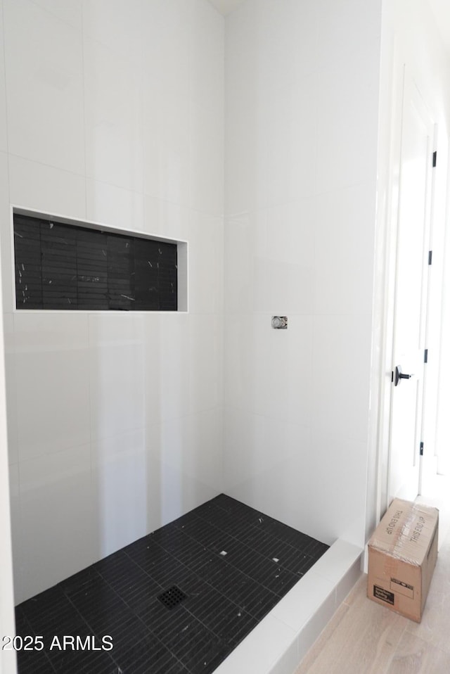 interior space featuring tiled shower