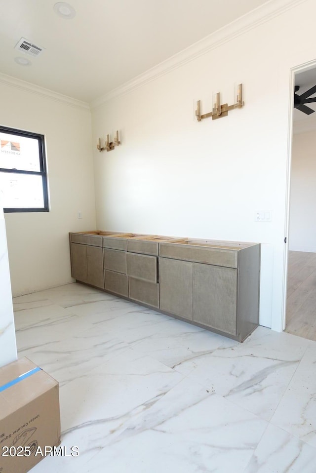 empty room with visible vents, marble finish floor, and crown molding