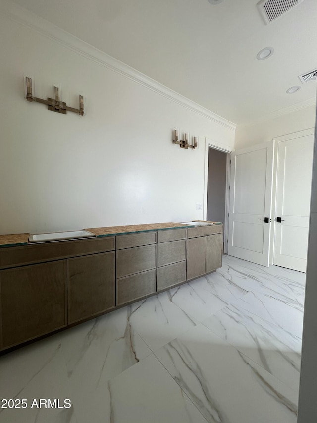 unfurnished room featuring visible vents, marble finish floor, and ornamental molding