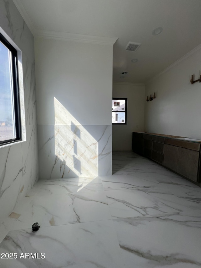 unfurnished room with crown molding, visible vents, and marble finish floor