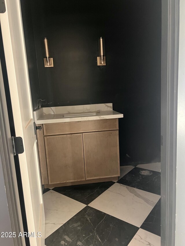 bathroom featuring marble finish floor and vanity