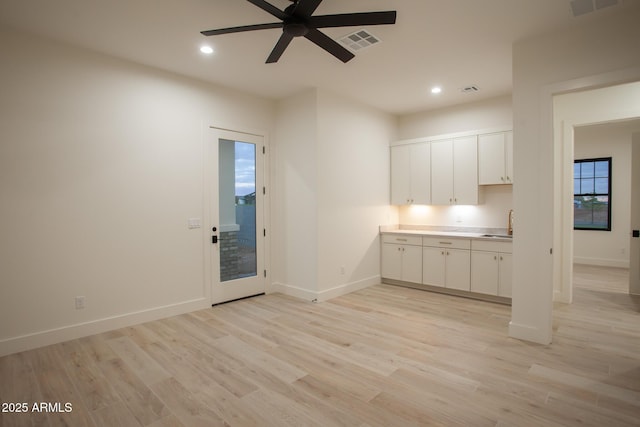 interior space featuring recessed lighting, visible vents, baseboards, and light wood-style flooring