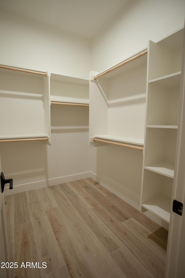 spacious closet with wood finished floors