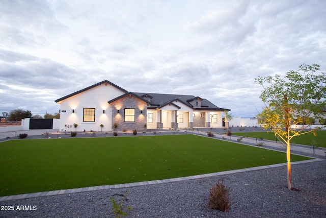 modern inspired farmhouse with a front yard and fence