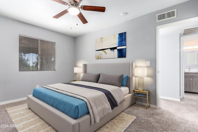 carpeted bedroom with ceiling fan and connected bathroom