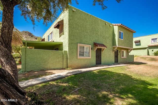 rear view of property with a lawn