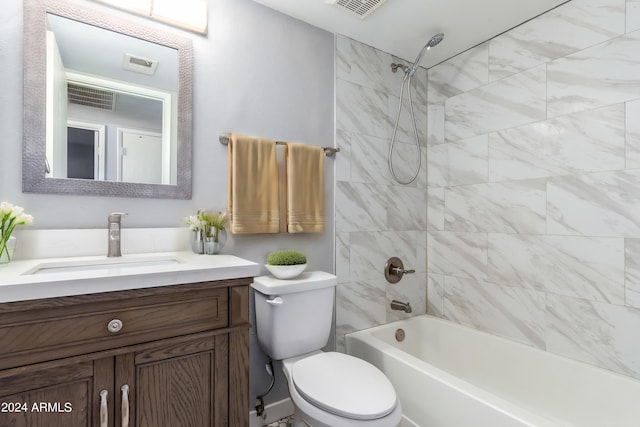 full bathroom with vanity, toilet, and tiled shower / bath combo