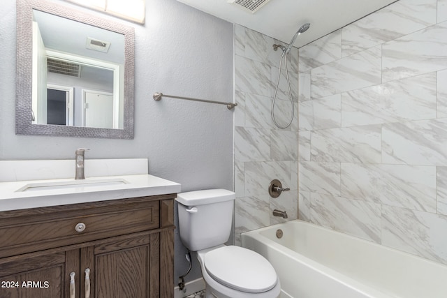 full bathroom featuring tiled shower / bath, toilet, and vanity