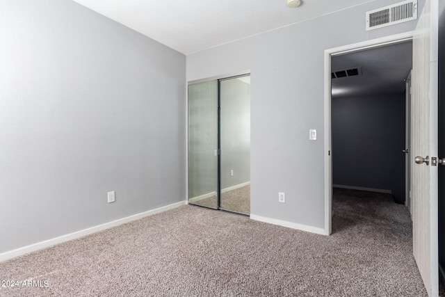 unfurnished bedroom with a closet and carpet floors