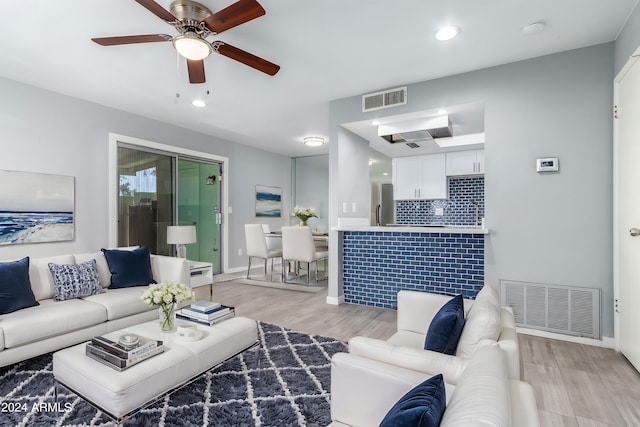 living room featuring light wood-type flooring and ceiling fan