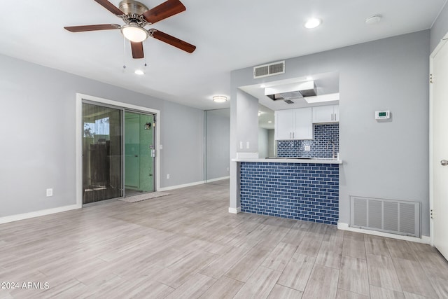 unfurnished living room featuring light hardwood / wood-style flooring and ceiling fan