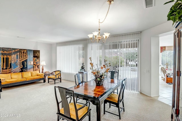 dining room with an inviting chandelier, a wealth of natural light, and light colored carpet