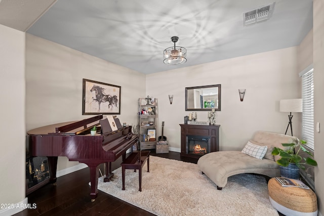 3766 E Ringtail Way, Phoenix, AZ 85050 - living area with dark wood-type flooring and a glass covered fireplace