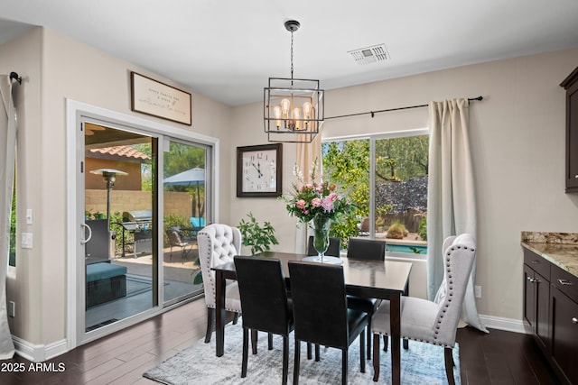 3766 E Ringtail Way, Phoenix, AZ 85050 - dining area with healthy amount of natural light, a chandelier, and dark wood finished floors
