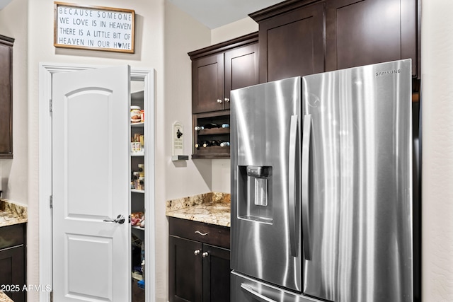 3766 E Ringtail Way, Phoenix, AZ 85050 - kitchen featuring stainless steel fridge, dark brown cabinetry, and light stone countertops