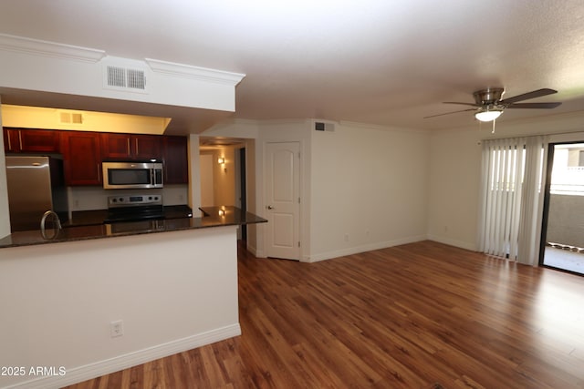 2025 E Campbell Ave Unit 120, Phoenix, AZ 85016 - kitchen featuring appliances with stainless steel finishes, reddish brown cabinets, a ceiling fan, wood finished floors, and ornamental molding