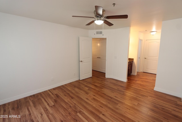 2025 E Campbell Ave Unit 120, Phoenix, AZ 85016 - empty room featuring wood finished floors, fire sprinkler in ceiling, and a ceiling fan