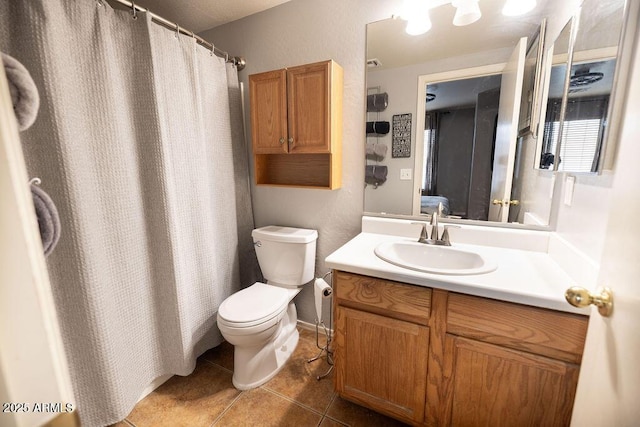 bathroom featuring vanity, toilet, and tile patterned flooring