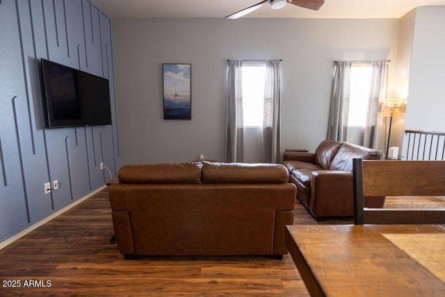 living room featuring dark hardwood / wood-style flooring and ceiling fan