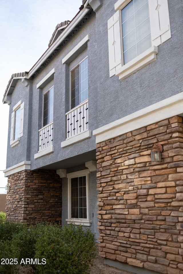 view of home's exterior with a balcony