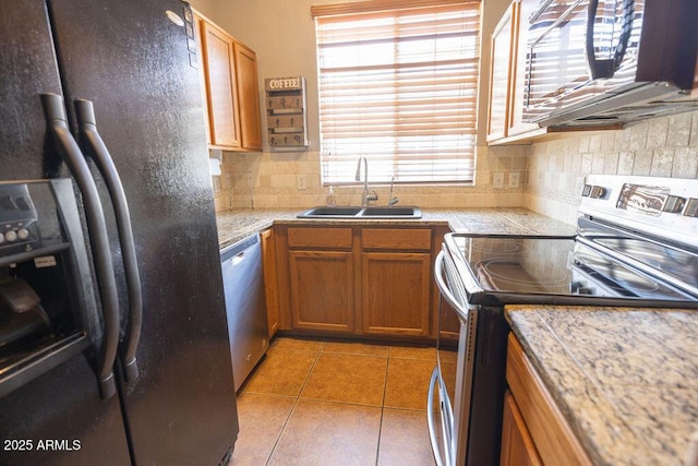 kitchen featuring tasteful backsplash, sink, light tile patterned floors, and appliances with stainless steel finishes