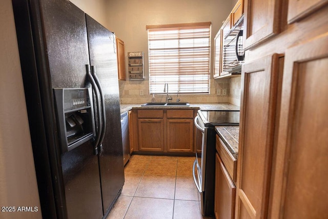 kitchen with stainless steel appliances, tasteful backsplash, sink, and light tile patterned floors