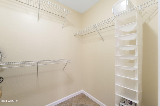 spacious closet featuring tile patterned floors