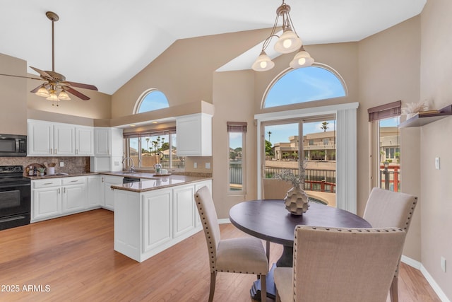 5822 W Abraham Ln, Glendale, AZ 85308 - dining space featuring high vaulted ceiling, light wood-type flooring, a ceiling fan, and healthy amount of natural light