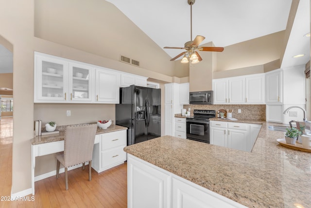 5822 W Abraham Ln, Glendale, AZ 85308 - kitchen with black appliances, ceiling fan, white cabinets, glass insert cabinets, and light wood-style flooring