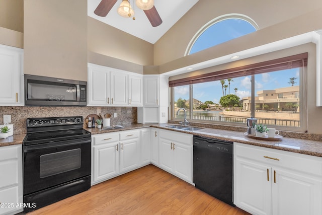 5822 W Abraham Ln, Glendale, AZ 85308 - kitchen featuring black appliances, ceiling fan, light wood finished floors, backsplash, and high vaulted ceiling