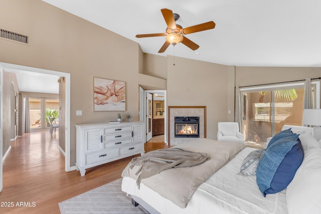 5822 W Abraham Ln, Glendale, AZ 85308 - bedroom featuring vaulted ceiling, a fireplace, wood finished floors, access to exterior, and ceiling fan