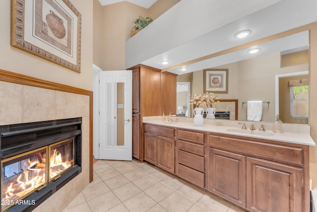 5822 W Abraham Ln, Glendale, AZ 85308 - full bath featuring a tile fireplace, double vanity, tile patterned flooring, and recessed lighting