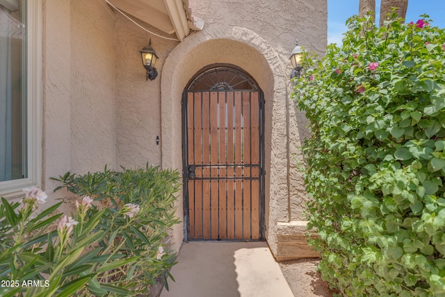 5822 W Abraham Ln, Glendale, AZ 85308 - doorway to property featuring stucco siding and a gate