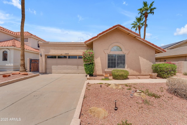 5822 W Abraham Ln, Glendale, AZ 85308 - mediterranean / spanish-style home with a garage, concrete driveway, stucco siding, and a tiled roof